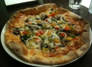 Pizza covered in mushrooms, onions and bell peppers at Narai Hotel.