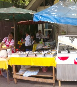 The confident smile of vendor who will sale all her food during lunch