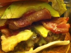 Closeup of the toppings on my Premium Burger from Firehouse (gorgonzola, bacon, avocado and caramelized onions)