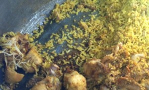 Scraping the bottom of a giant boiler of biryani by 9am