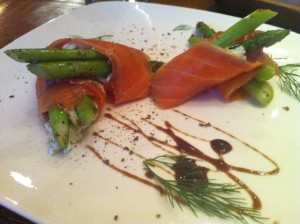 Asparagus planted in dill cheese and wrapped in salmon, an appetizer at Seven Spoons