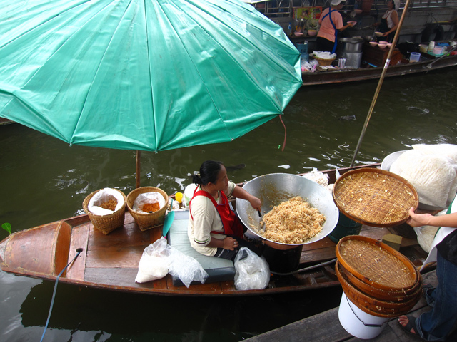 Serving food straight from her boat!